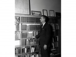 Photo of Little in front of bookcase