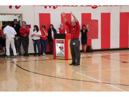 Photo of Dr. Stern getting students & staff fired up during pep rally