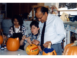 Photo of Dr. Vasishta & students paint pumpkins - 1995