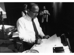 Photo of Dr. Vasishta signing document