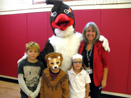 Photo of Dr. Gallegos, students & NMSD's Mascot Rusty the Roadrunner