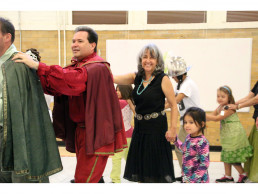 Photo of Dr. Gallegos, students and Santa Fe Fiesta Court dancing